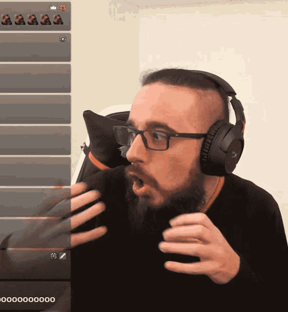 a man wearing headphones and glasses looks surprised in front of a screen that says 000000
