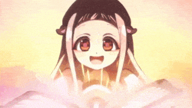 a girl is sitting in front of an open book with her eyes closed