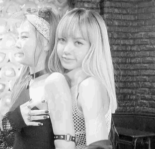a black and white photo of two young women standing next to each other