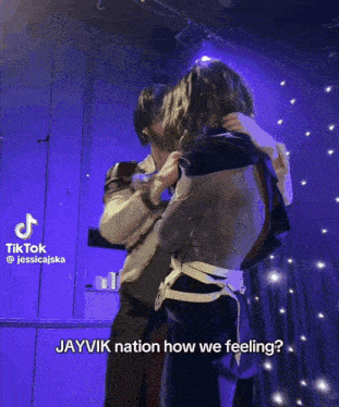 a blurry picture of two people dancing with tiktok written in the corner