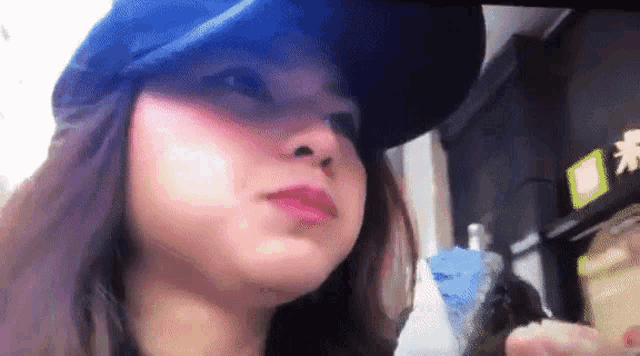 a close up of a woman wearing a baseball cap
