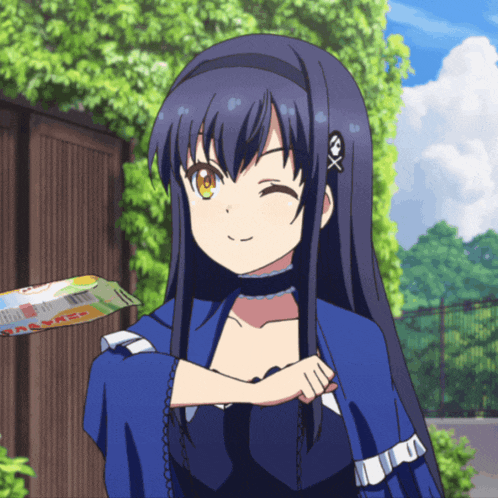 a girl with a skull and crossbones headband winks at the camera