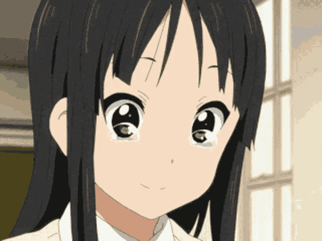 a close up of a girl 's face with her eyes closed