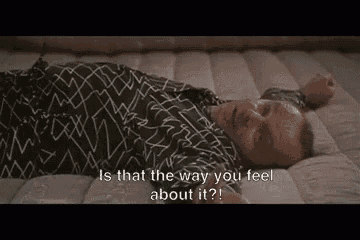 a man is laying on a bed with his arms outstretched and says `` is that the way you feel about it? ''