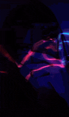 a woman is taking a picture of herself with a neon heart and the name sila on the bottom