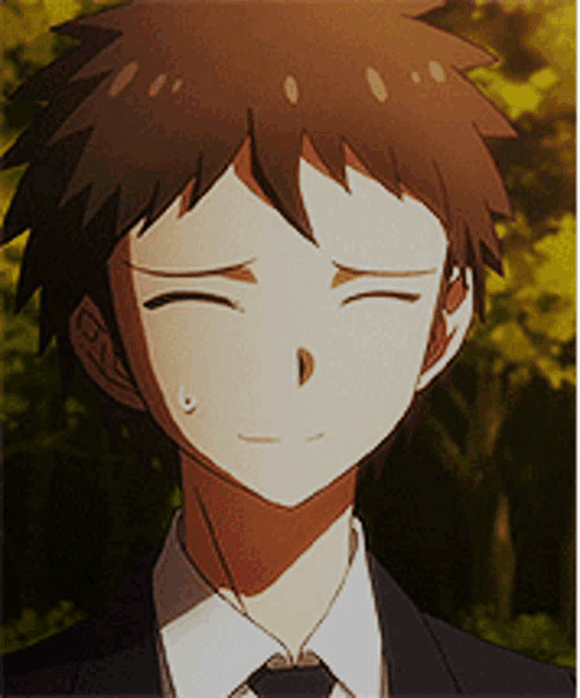 a young man in a suit and tie is smiling
