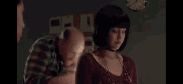 a woman is looking at herself in a mirror