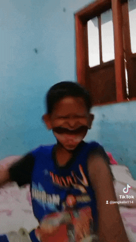 a young boy wearing a blue shirt that says thunder on it