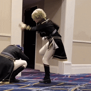 a man in a military uniform is kneeling down next to a woman in a black dress