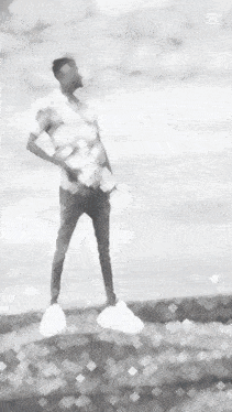 a black and white painting of a man standing on a hill