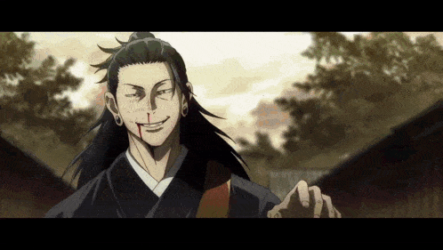 a man in a kimono with blood on his face is smiling and giving a thumbs up .