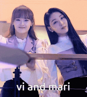a couple of women standing next to each other with the words vi and mari behind them