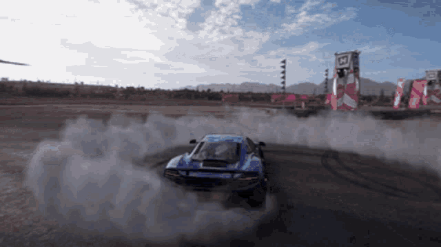 a car is drifting on a track with smoke coming out of the tires