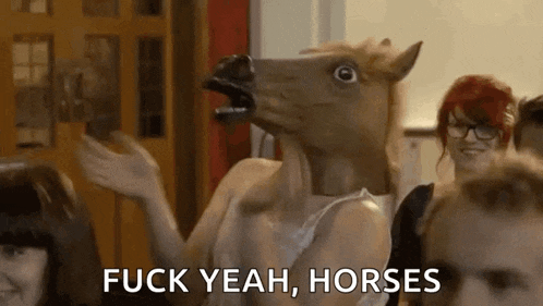 a woman wearing a horse mask is standing in front of a crowd of people .