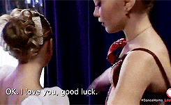 two girls are standing next to each other and one of them is saying ok i love you good luck