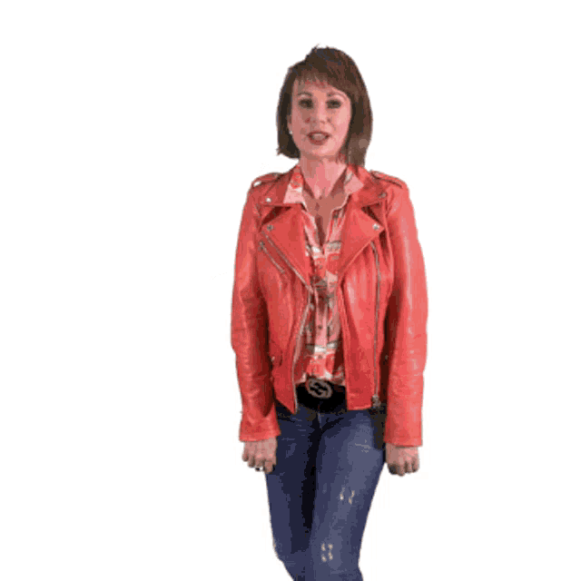 a woman wearing a red leather jacket and jeans is dancing