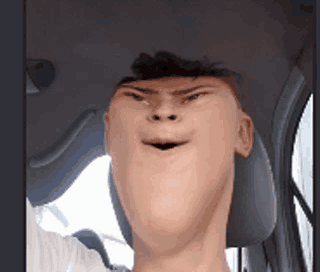a man is making a funny face while driving a car