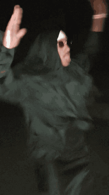 a man dressed as a nun with sunglasses and a bandana on his head