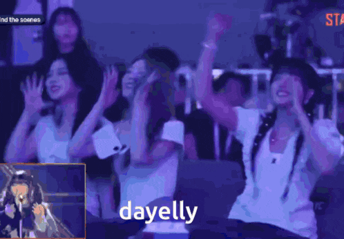 a group of people are sitting in a dark room and the word dayely is on the bottom right