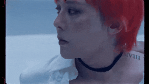 a person with red hair has a tattoo on their neck that says " viii "