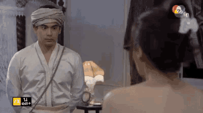 a man in a turban is looking at a woman in a bathing suit