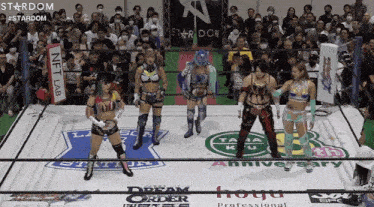 a group of women wrestling in a ring with a sign that says stardom