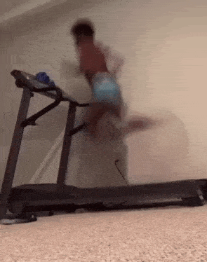 a person is running on a treadmill with a blurred background