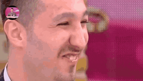 a close up of a man 's face with a man in a suit behind him
