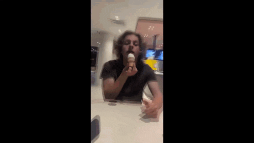 a man is eating an ice cream cone with the words he can do it better than me written below him