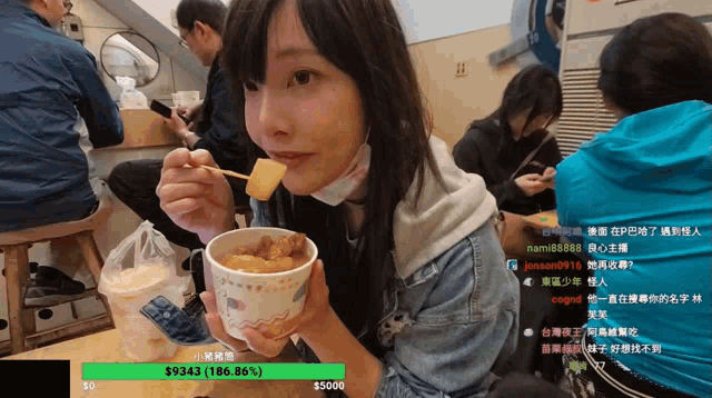 a woman holding a cup of food with a sticker that says $ 9343 on it