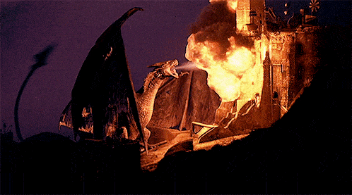 a dragon is standing in front of a burning castle