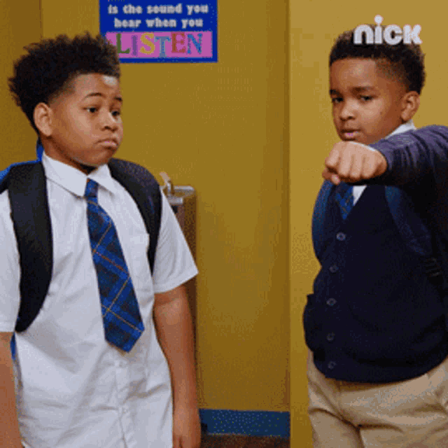 two boys are standing in front of a sign that says " is the sound you hear when you listen "