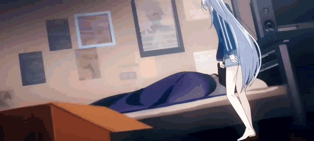 a girl with long white hair is standing next to a bed with a blanket on it .