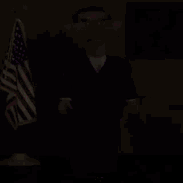 a cartoon of barack obama in a purple suit standing in front of an american flag