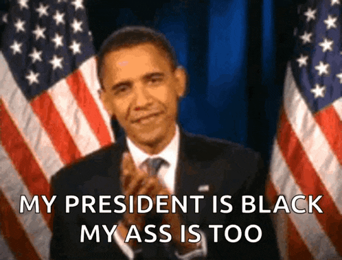 a man in a suit and tie is standing in front of an american flag and says " my president is black my ass is too "