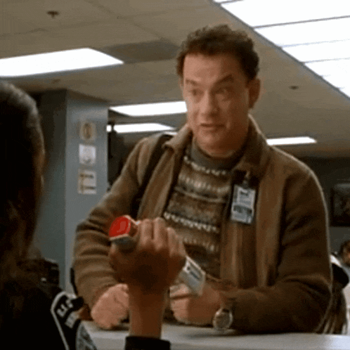 a man in a brown jacket has a name tag on his chest that says ' a. j. '