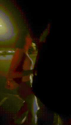 a blurry picture of a person walking down the street at night .