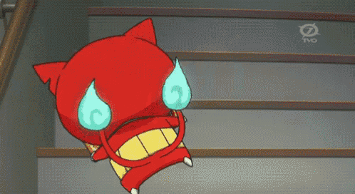 a red and white cartoon cat is standing on a set of stairs ..