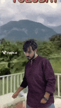 a man in a purple shirt is standing on a balcony with a mountain in the background