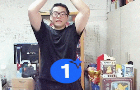 a man in a black shirt stands in a room with a blue circle with the number 1 on it