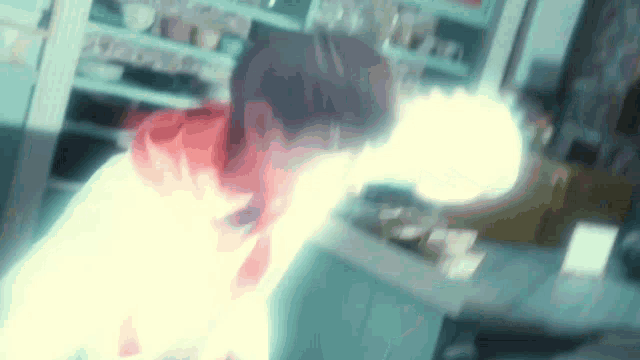 a blurry picture of a person with a light coming out of their face .