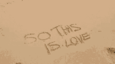 the word sotu is written in the sand on the beach .