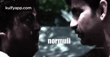 two men are looking at each other and the word normui is on the bottom of the screen .