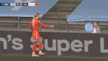 a soccer player wearing a red shirt that says cazo stands on the field