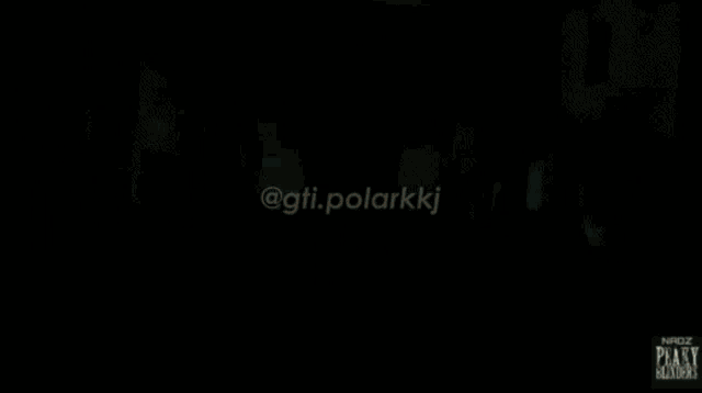 a man in a suit and tie is standing in a dark room