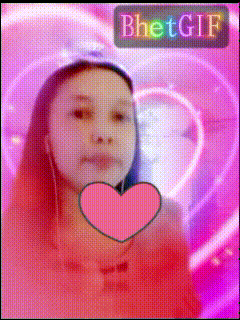 a girl is holding a pink heart in front of her face and the word bhet gif is above her
