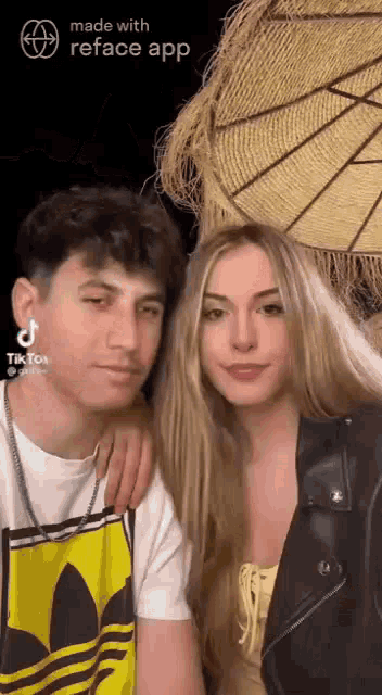 a man and a woman are posing for a picture together . the woman is wearing a yellow top .