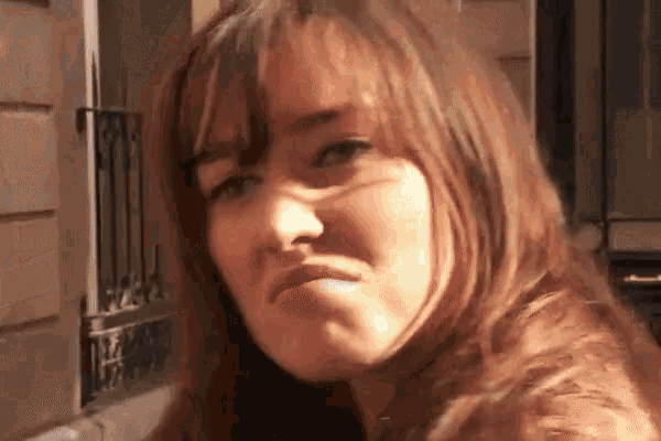 a close up of a woman 's face making a funny face
