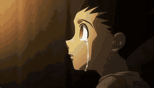 a young boy is crying with a tear running down his face .