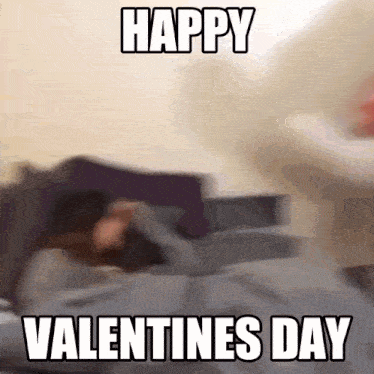 a blurred image of a person laying on a bed with the words happy valentines day below them
